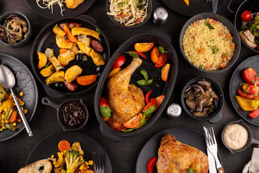 A variety of dishes featuring roasted chicken and colorful vegetables demonstrating food flavor pairing techniques.
